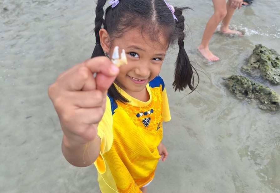 LIS grade 1 little girl holding a shell