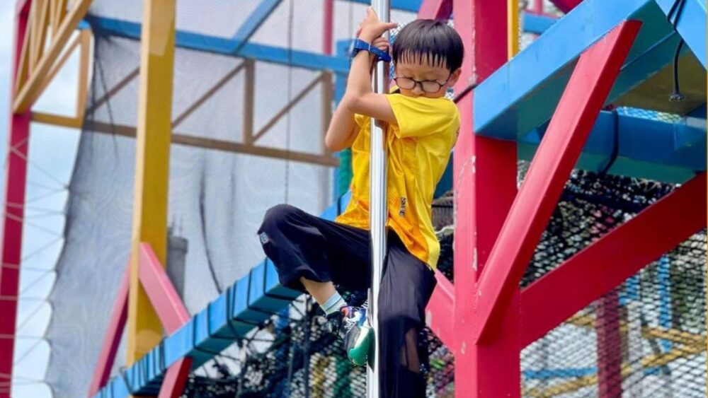 Kid sliding on a pole