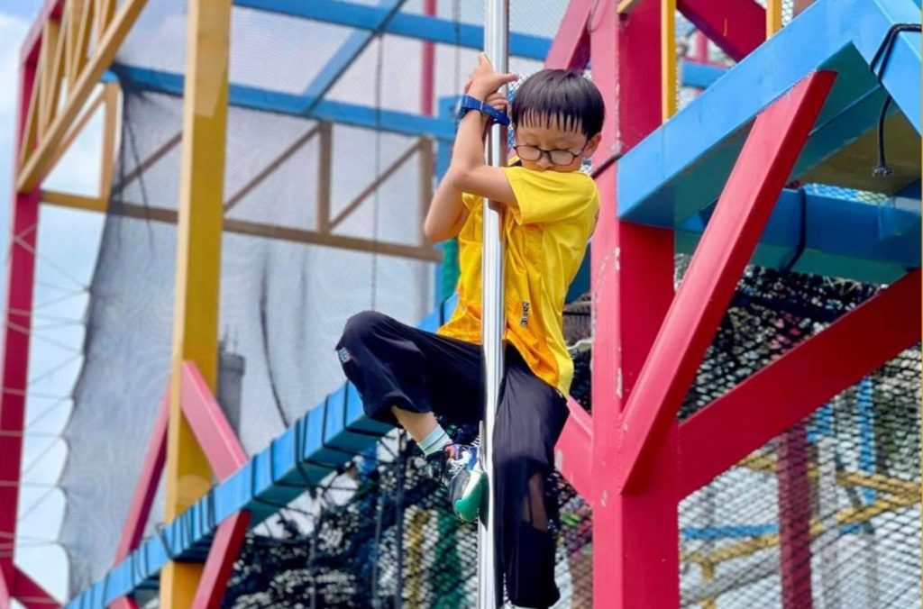 Kid sliding on a pole