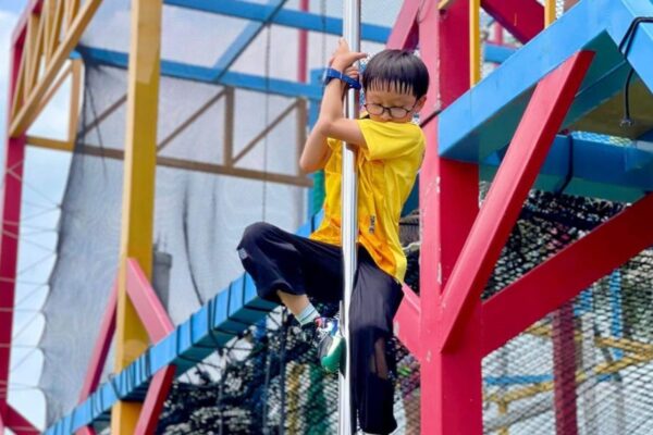 Kid sliding on a pole