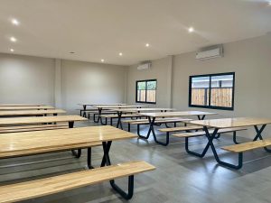 Tables and benches in a room equipped with airconditioning