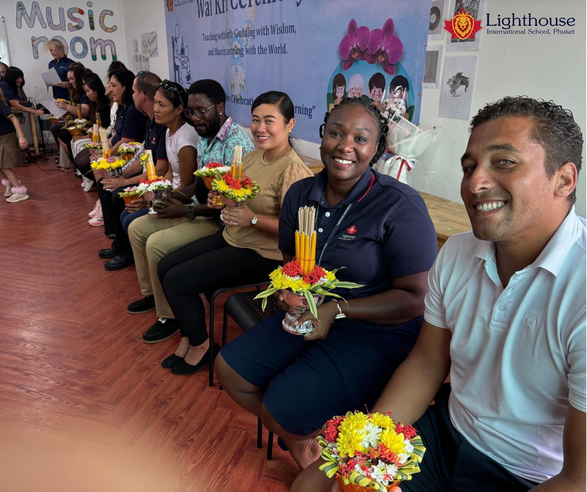 Teachers smiling at the camera with their flowers