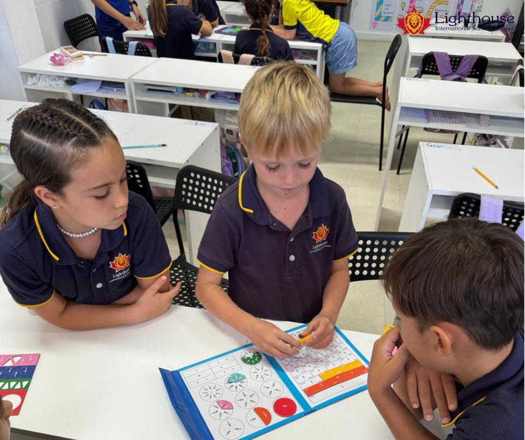 Primary school students working on an activity book together