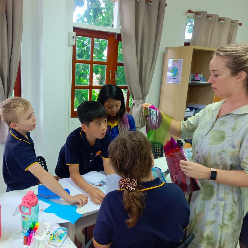 Teacher guiding the students with their work