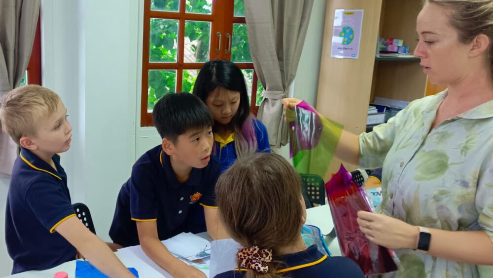 Teacher guiding the students with their work