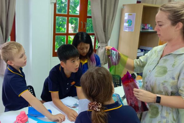 Teacher guiding the students with their work