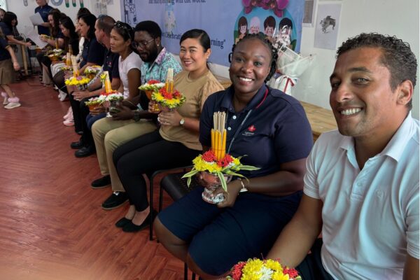 Teachers smiling at the camera with their flowers
