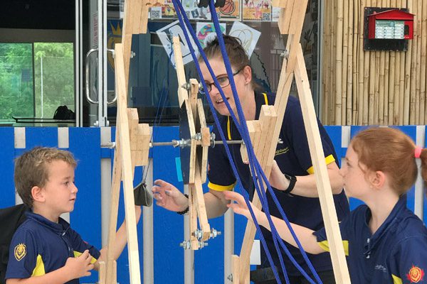 education-science-demonstration-lighthouse-primary-rawai A teacher showing a science project demonstration to primary students