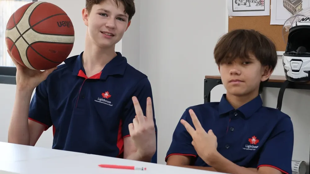 Two students doing a pose sign for the camera