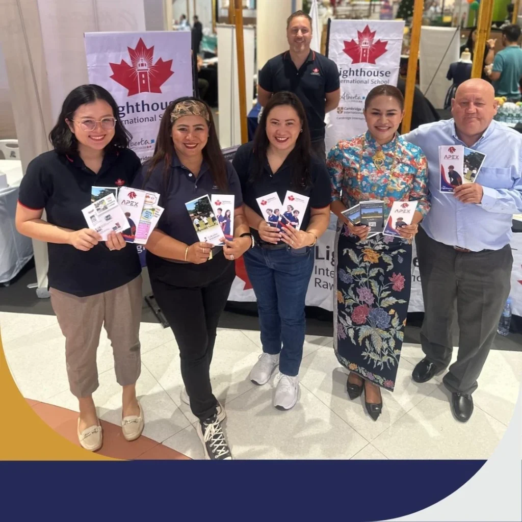 Staff holding booth pictures during education hub