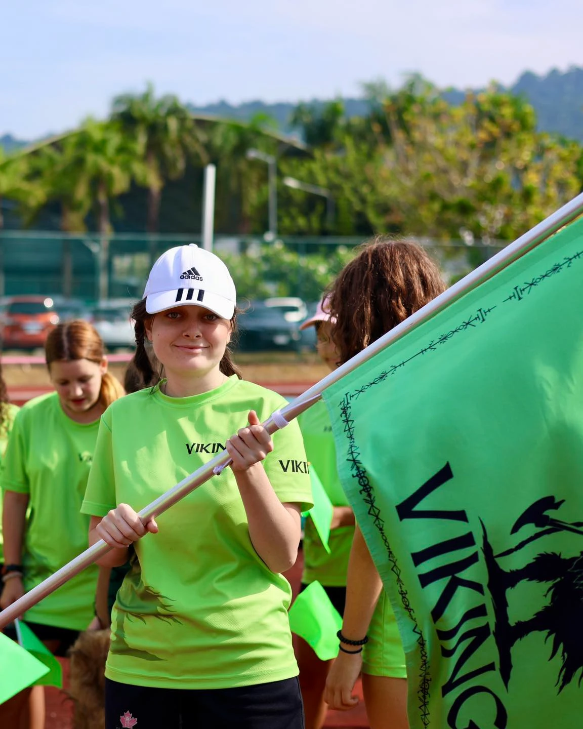 Student holding their team flag