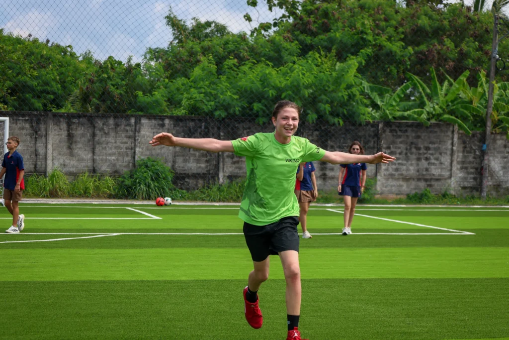 Student smiling in the football field