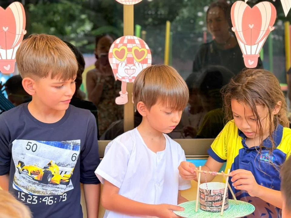 Three students collaborating on a well project