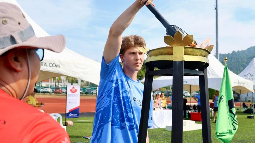 student lighting the torch