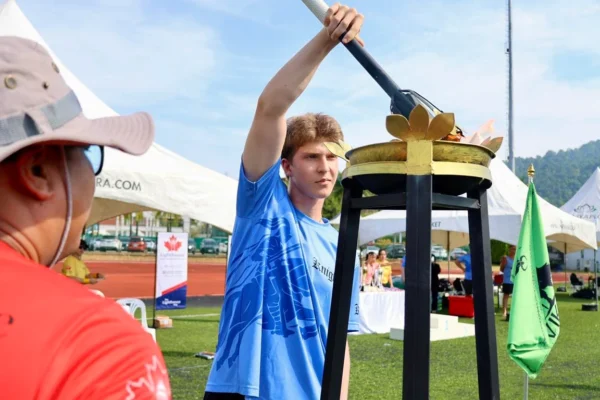student lighting the torch