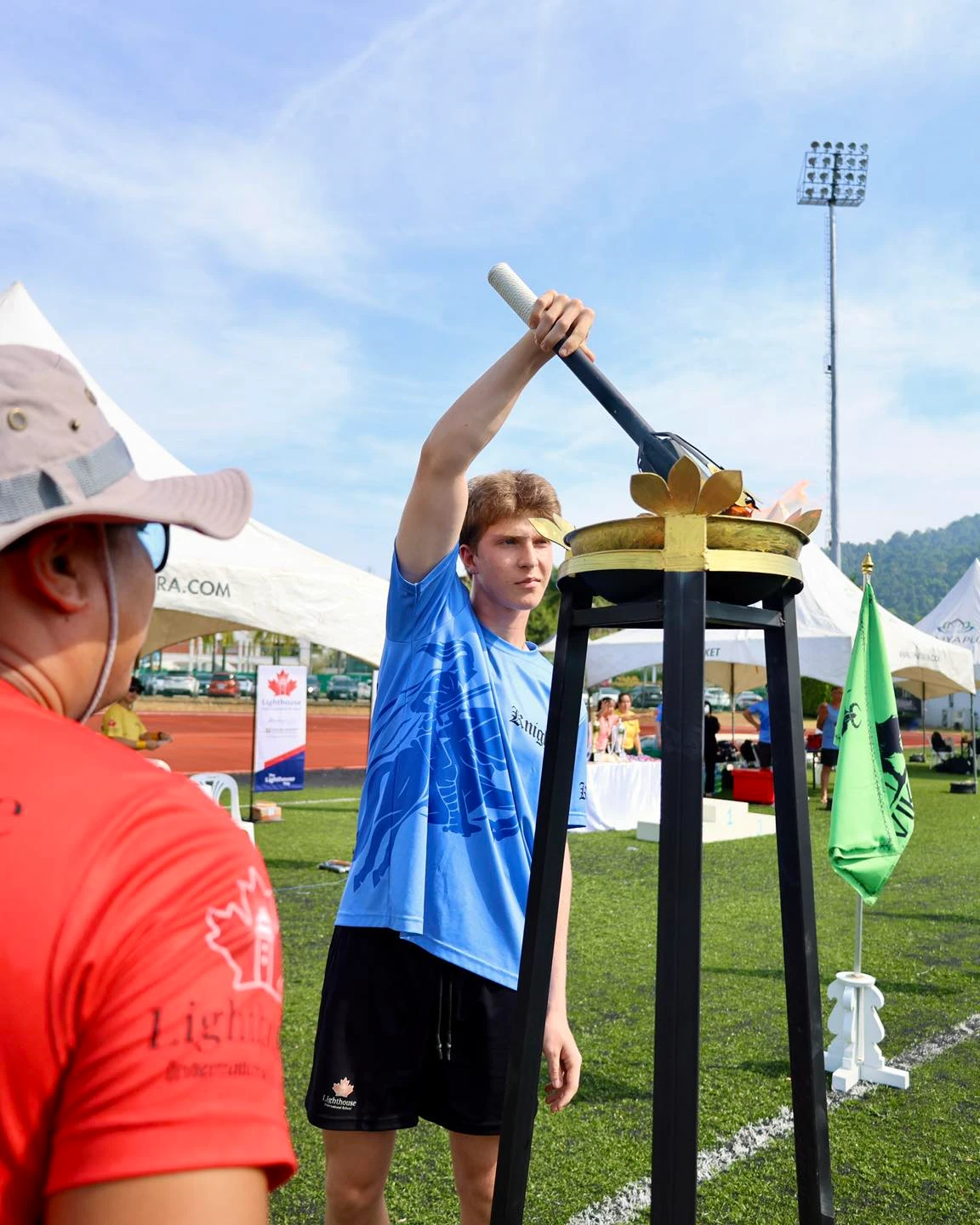 student lighting the torch