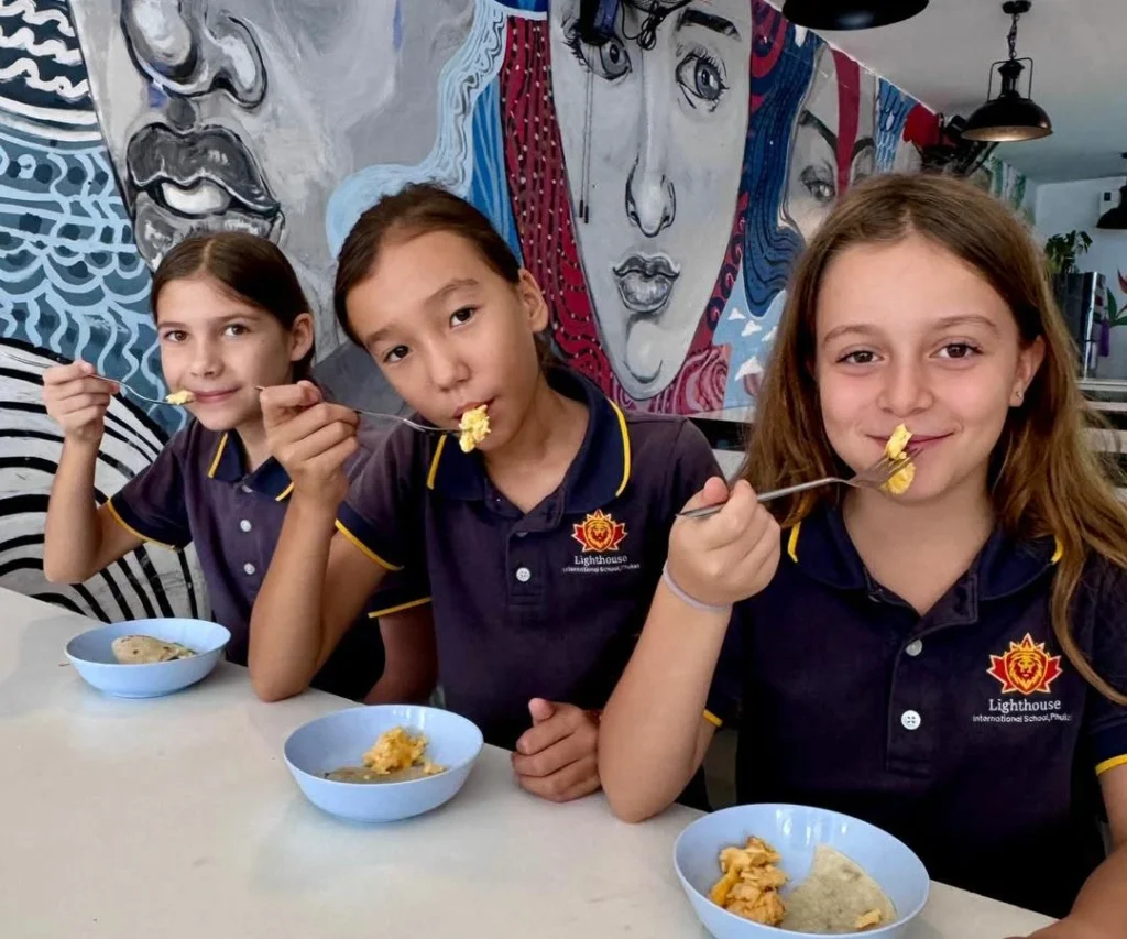 Girls posing together while eating snacks