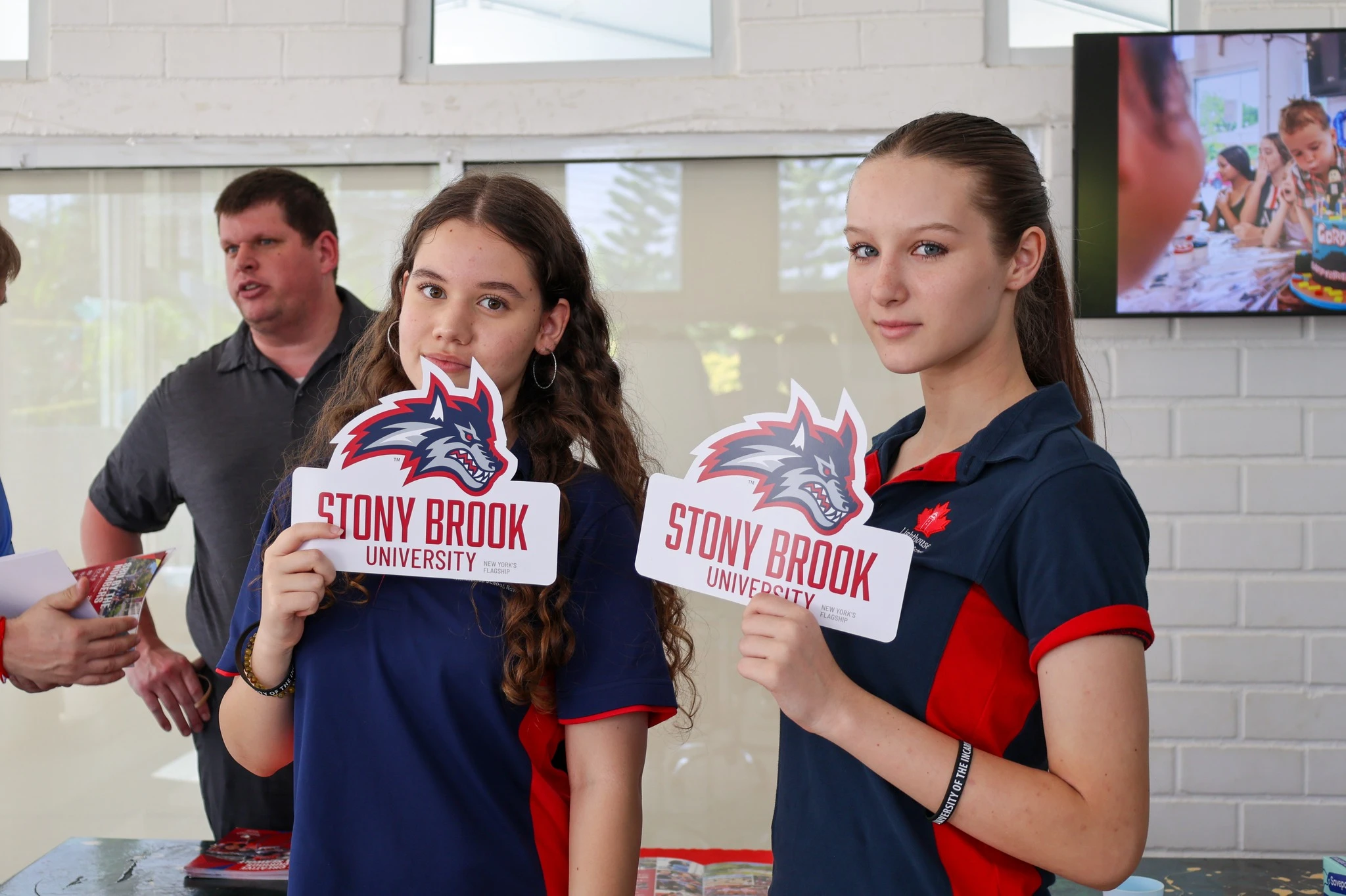 Lighthouse Students holding school logo placards