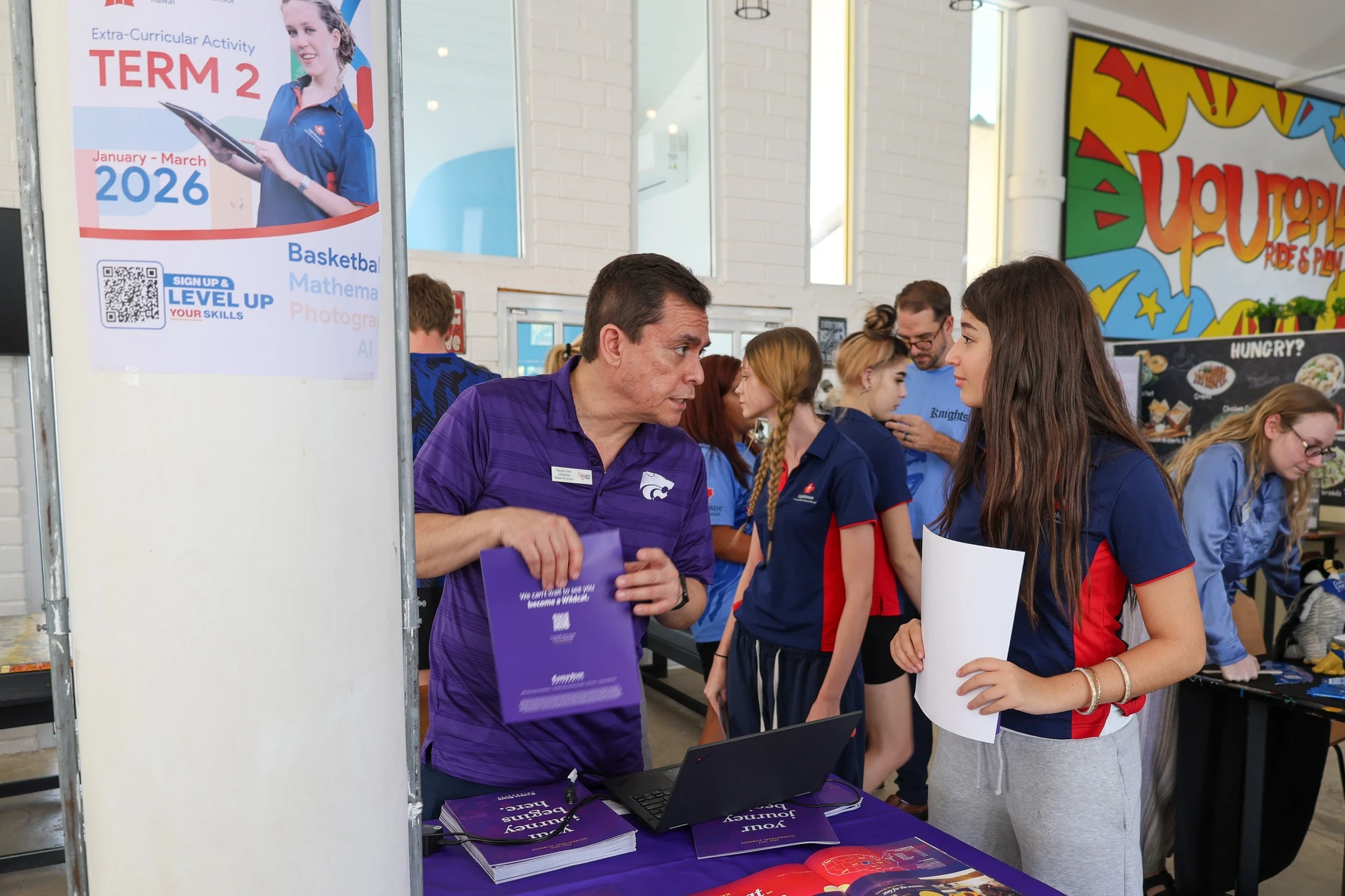 Student and teacher talking about university fair