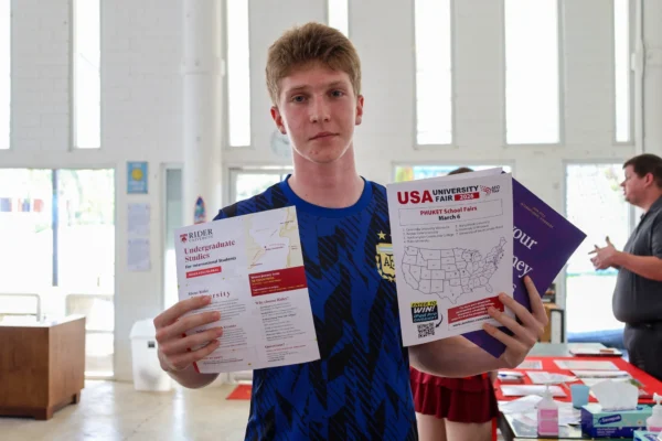Student holding USA University fair materials