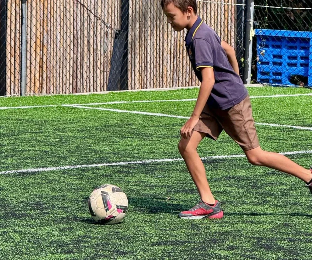Student kicking a ball
