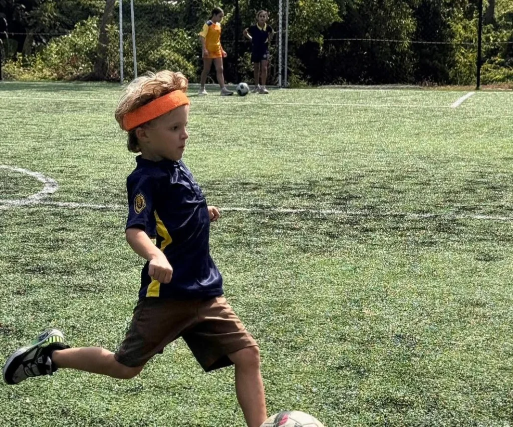 Young student kicking a football