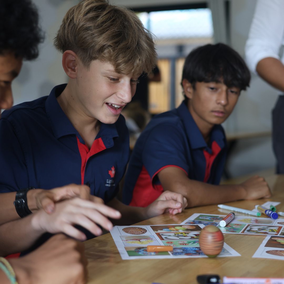 Boys looking at an easter egg on the desk