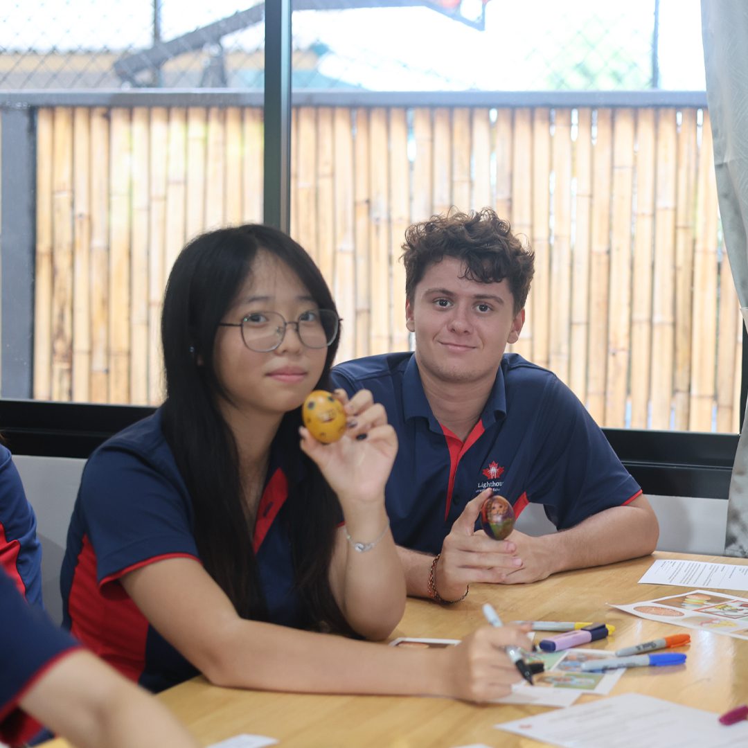 Classmates posing for a pic with an easter egg