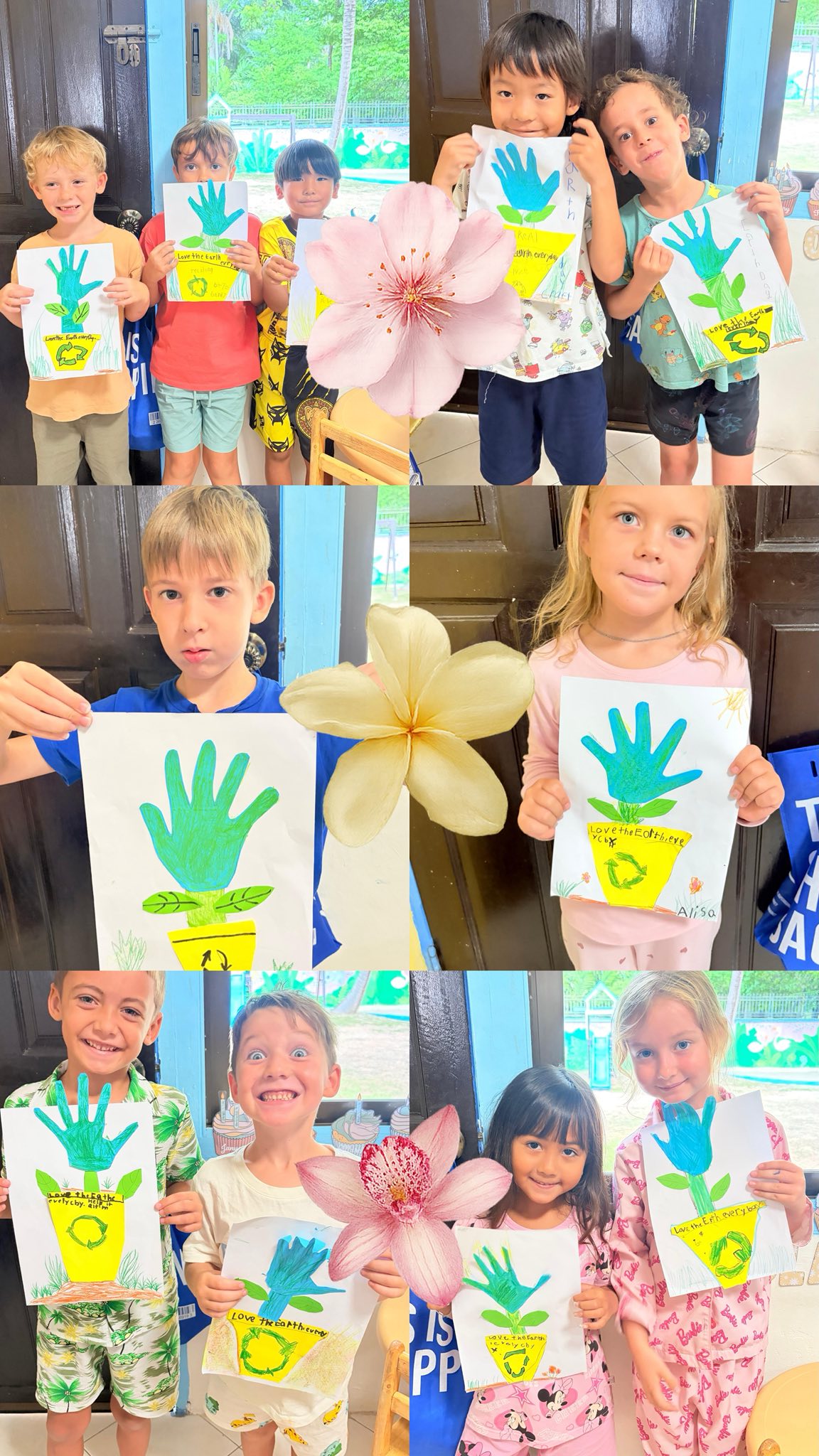 Kindergarten students holding up earth day arts