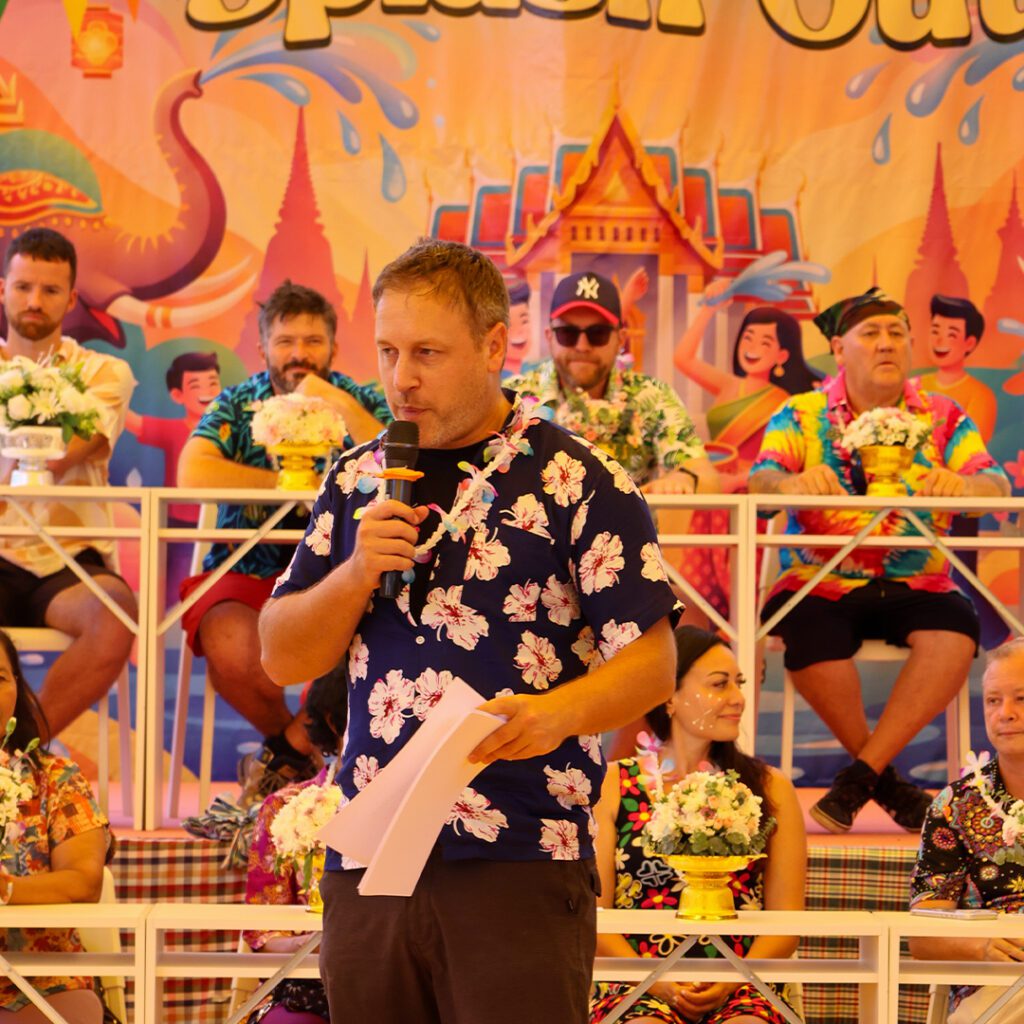 School head speaking during Songkran celebration