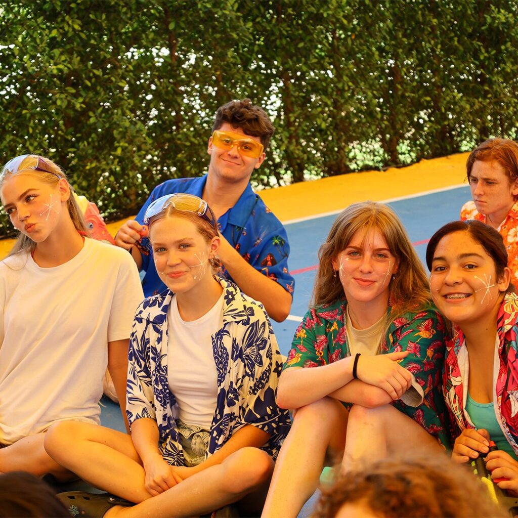 Secondary students smiling for the photo while wearing floral shirts