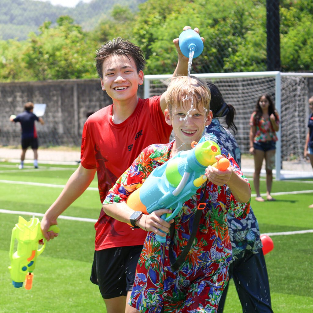 Youth holding waterguns