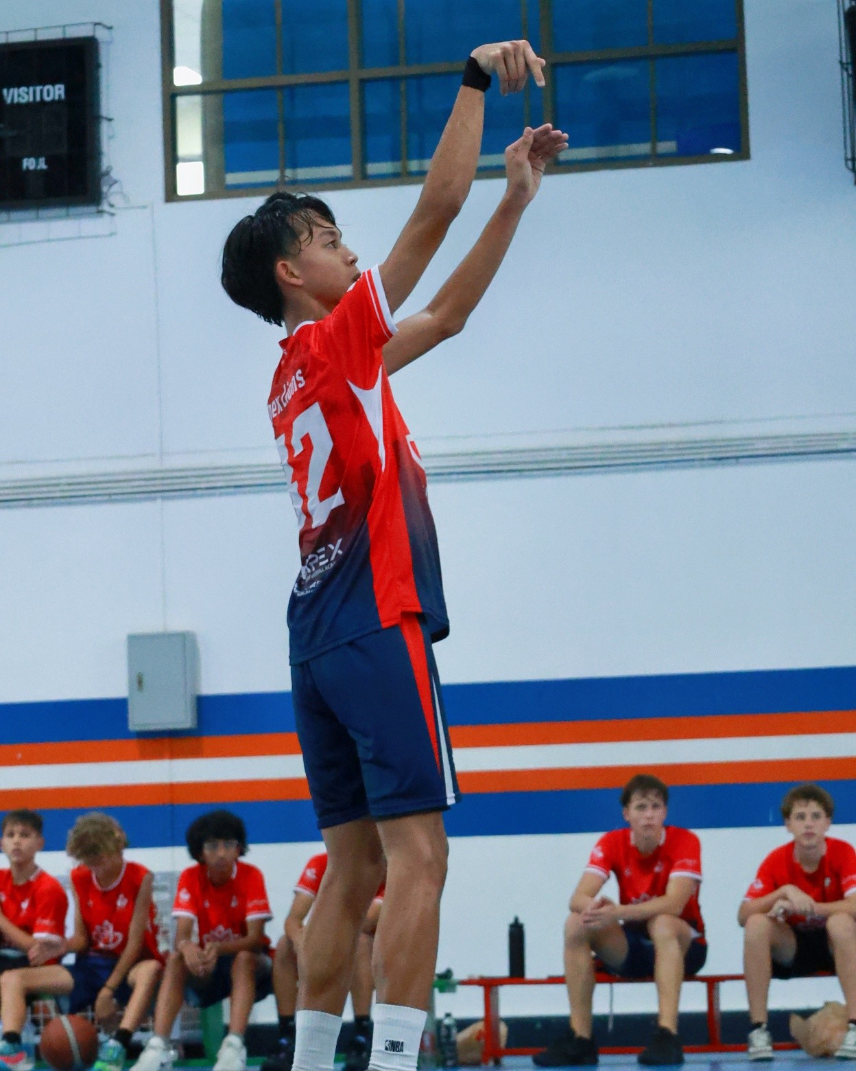 LIS student basketball shooting hoop