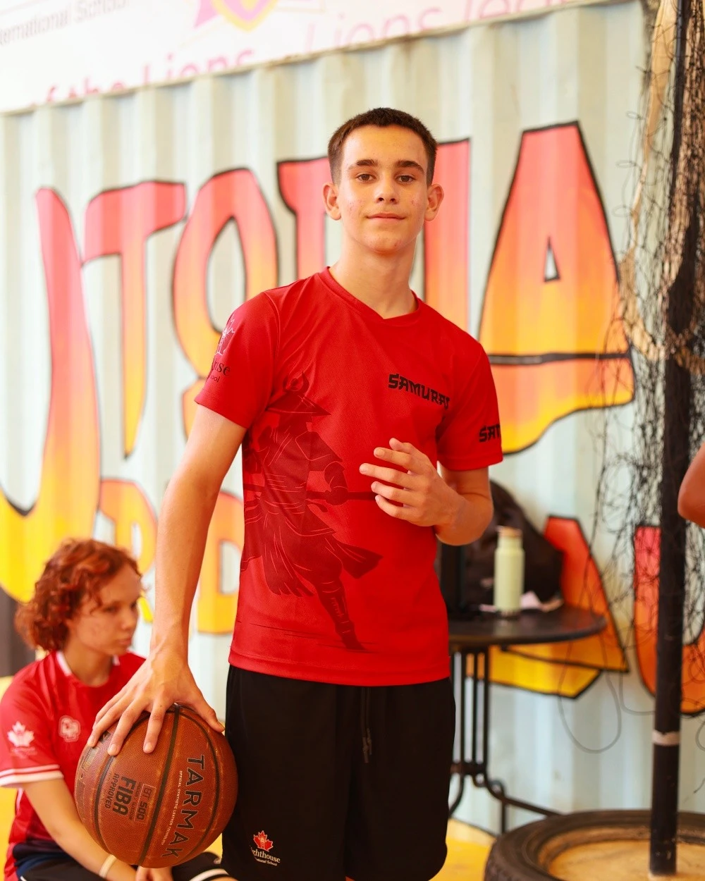 Lighthouse student holding a basketball