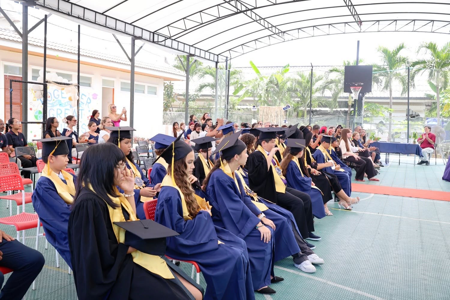 6th grade graduates of Lighthouse International School Phuket, sitting down