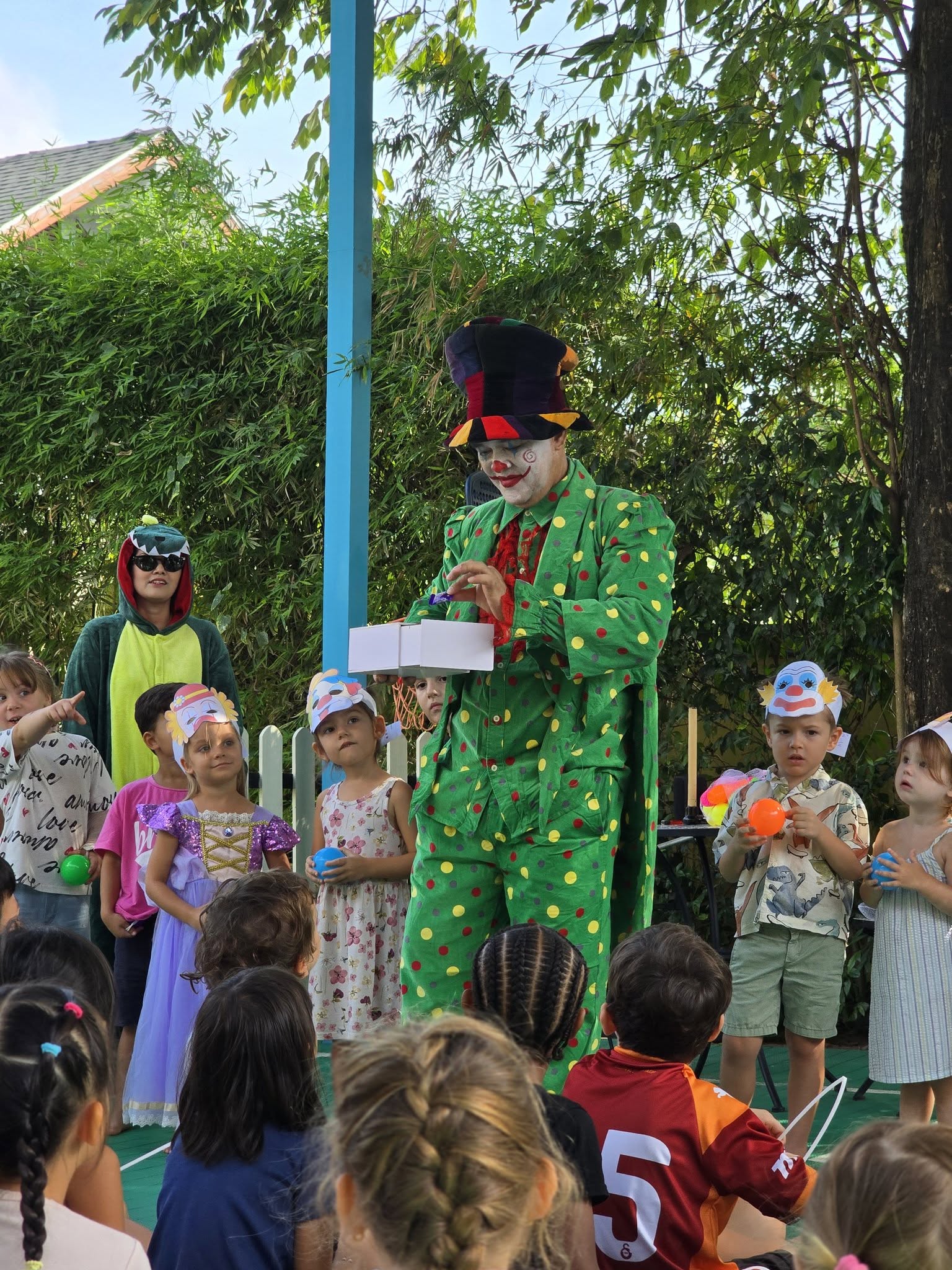 Clown performing in front of students