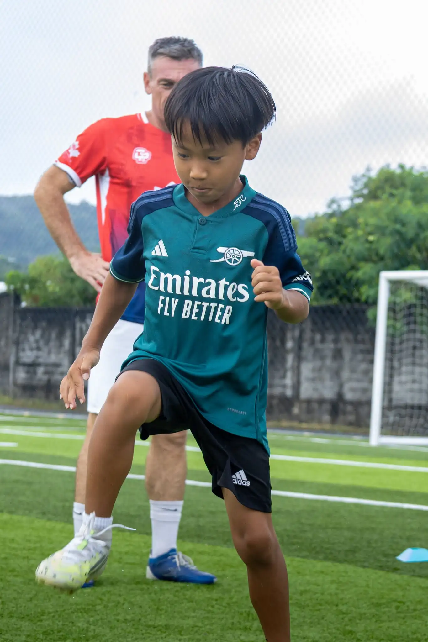 Boy being trained for football camp
