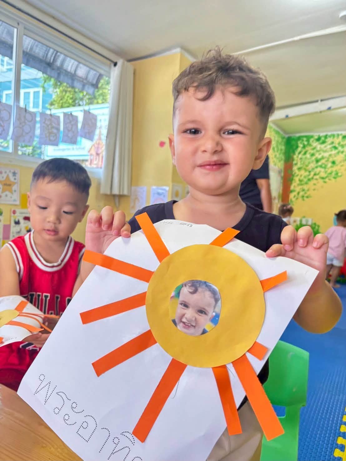 Boy holding his activity for Kindergarten summer school
