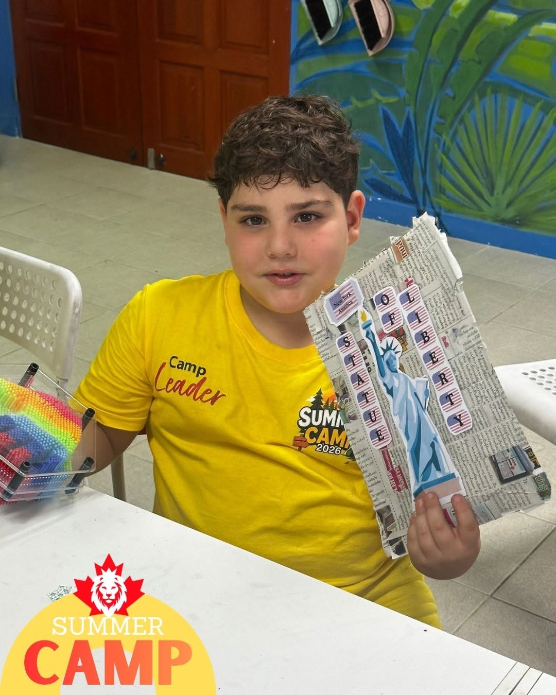 Camp leader student holding an activity kit during Primary Summer Camp at Lighthouse International School