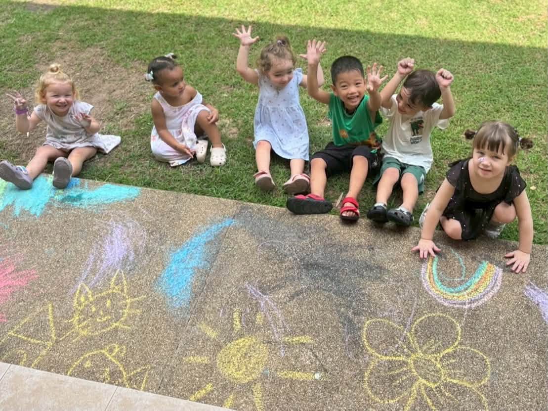 Children drawing chalk on the ground