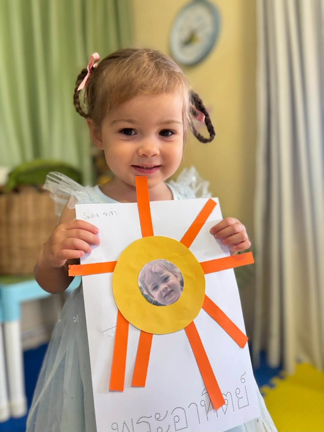 Girl holding his activity for Kindergarten summer school