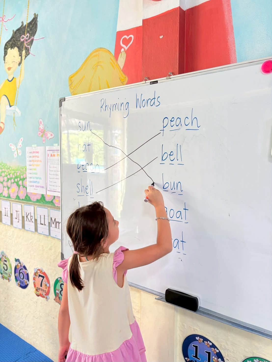 Girl matching rhyming words during Kindergarten Summer School