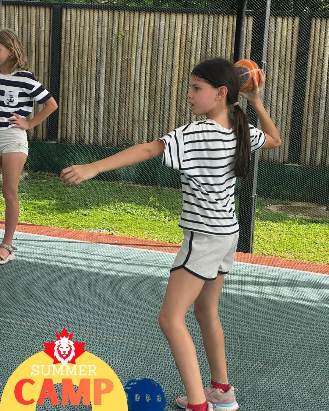 Girl throwing ball stance at Primary Summer Camp