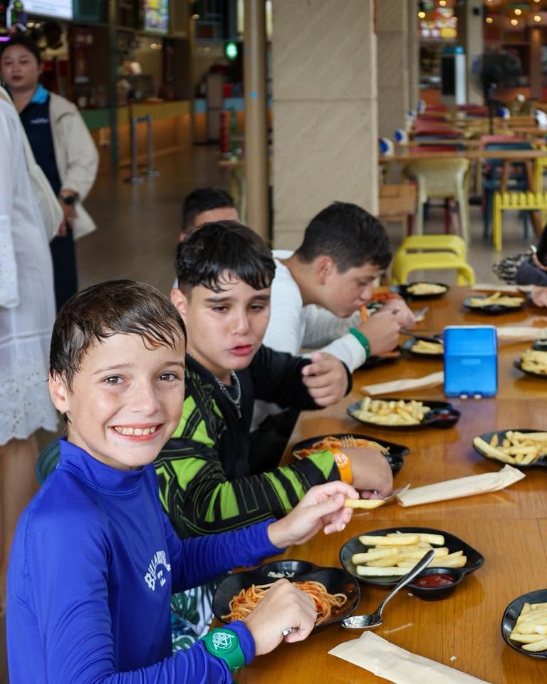 Lighthouse International School Students eating at the cafe after playing in the pool Lighthouse International School Students eating at the cafe after playing in the pool