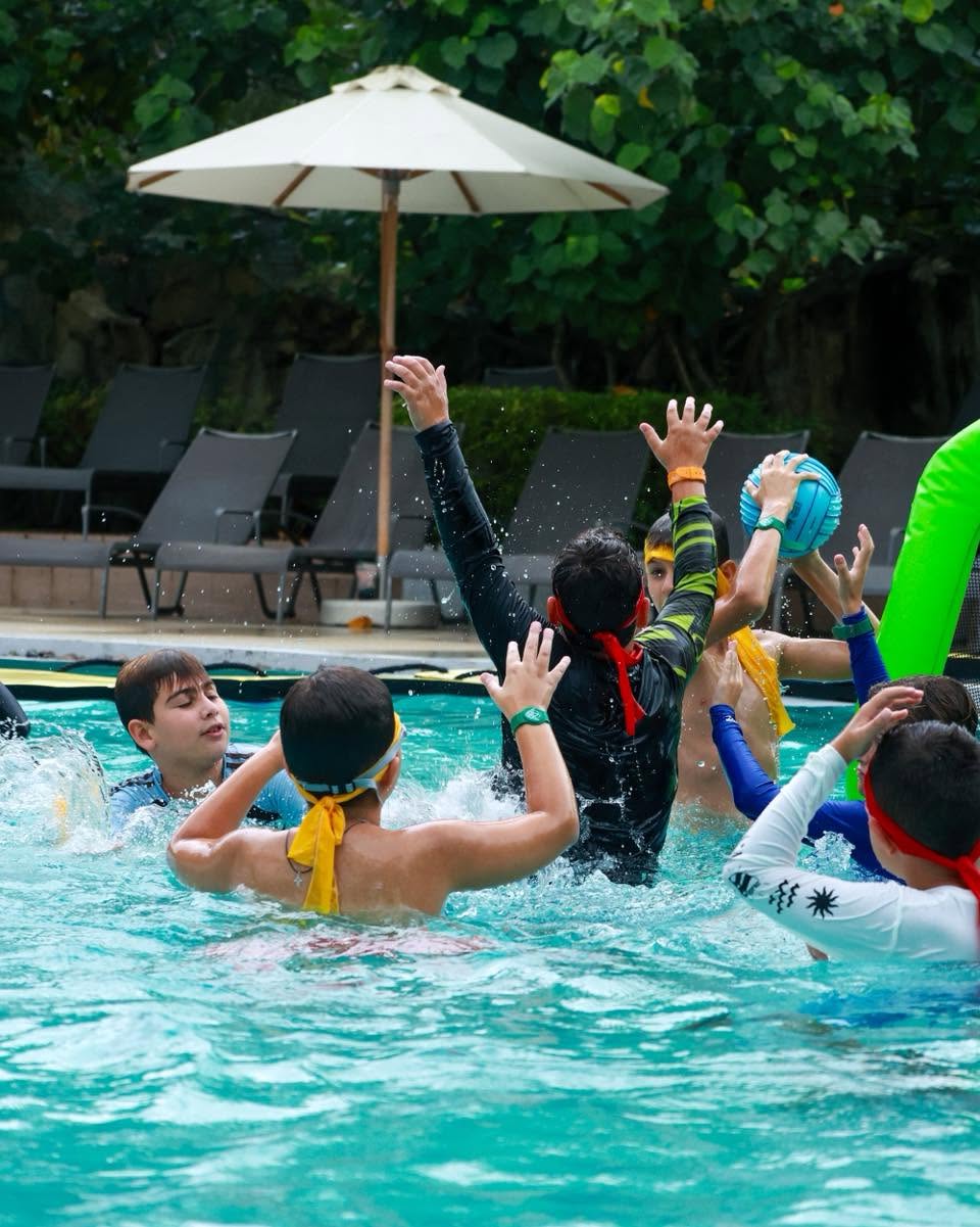 Lighthouse International School students playing volleyball in the pool Lighthouse International School students playing volleyball in the pool