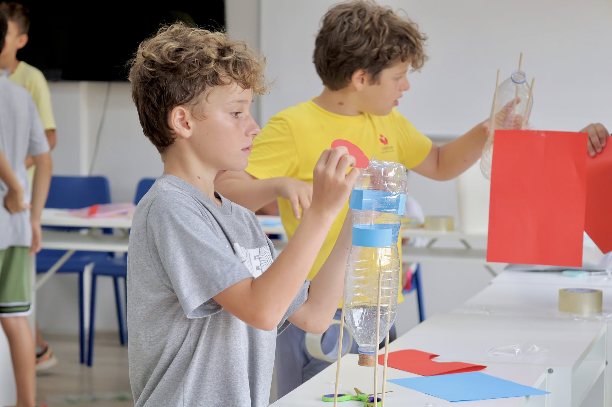 Students creating rocket from plastic bottles Students creating rocket from plastic bottles
