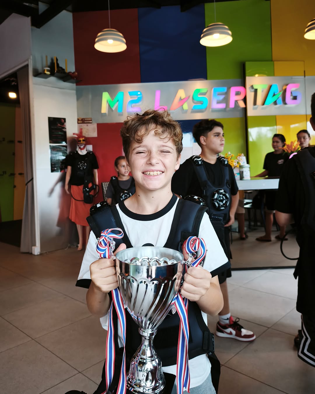 Boy holding trophy for winning laser tag - Lighthouse