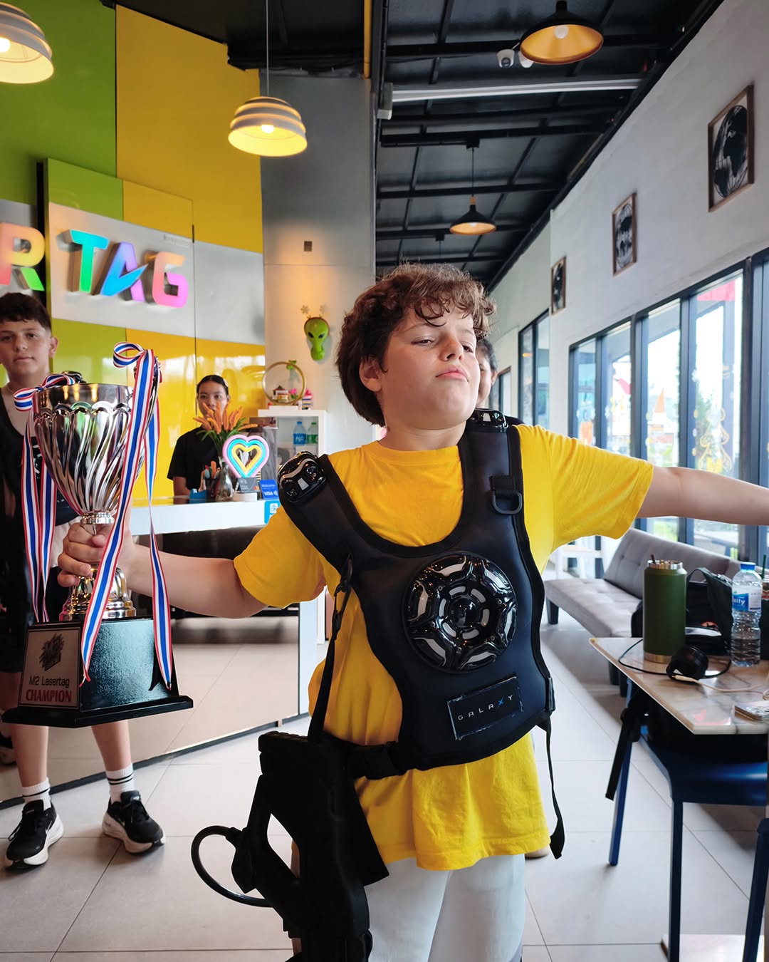Boy posing trophy for winning laser tag - Lighthouse