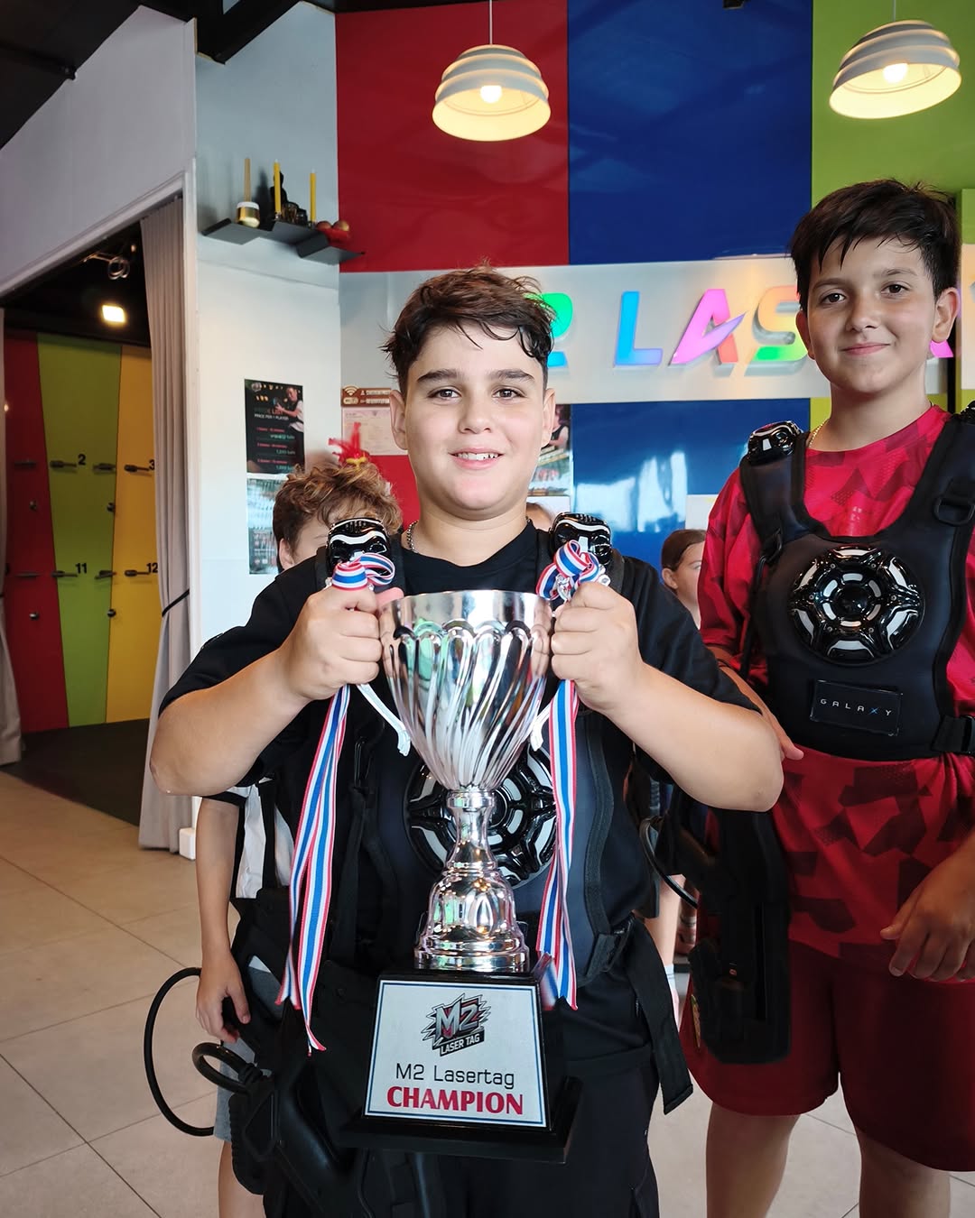 Boy posing with trophy for winning laser tag - Lighthouse