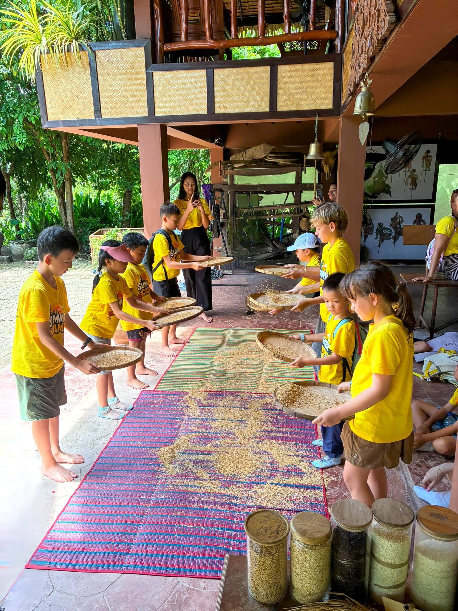 Farmer teaching Lighthouse Phuket students about rice